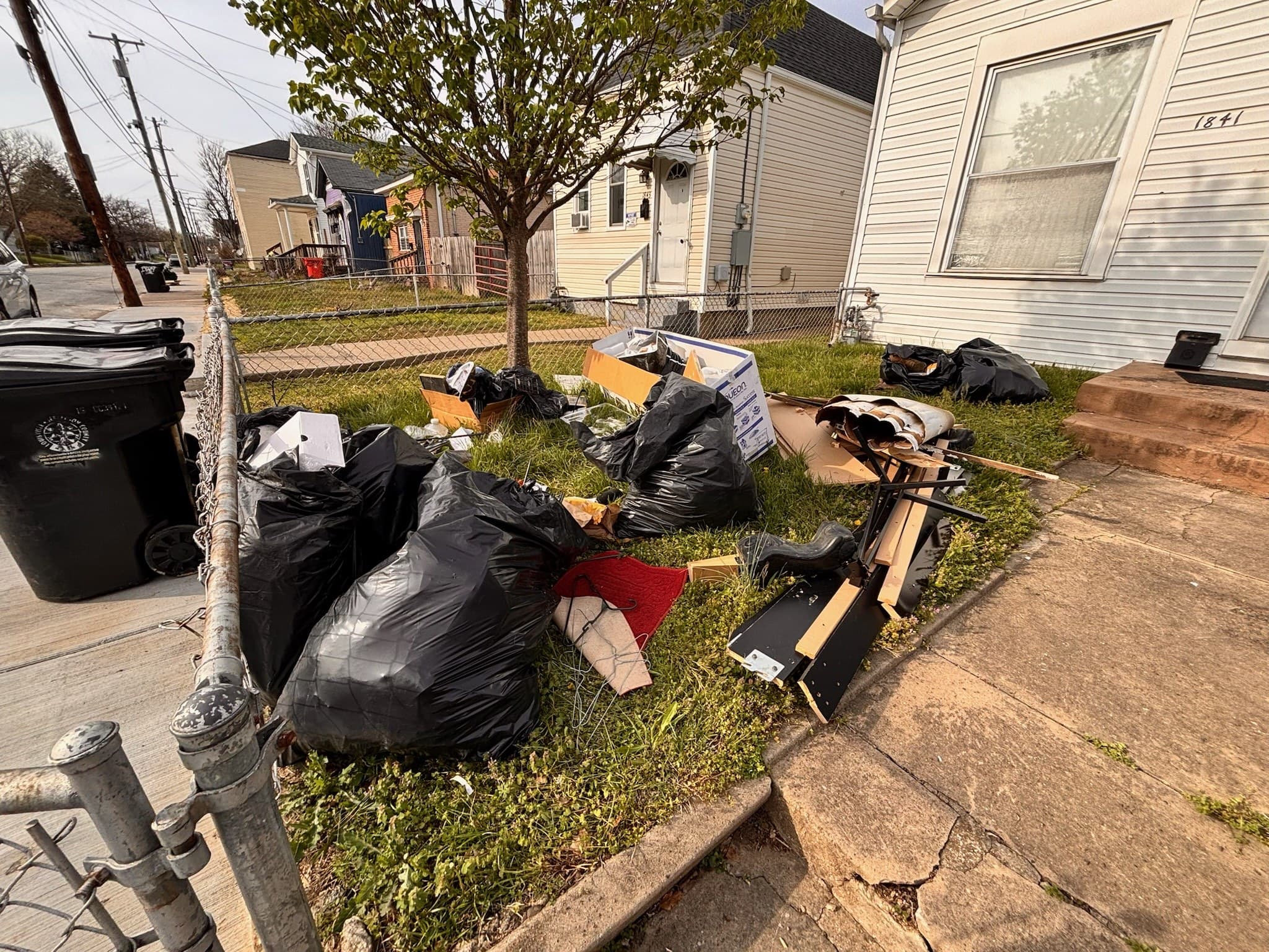 Bags and household debris before a Bag It Up cleanout