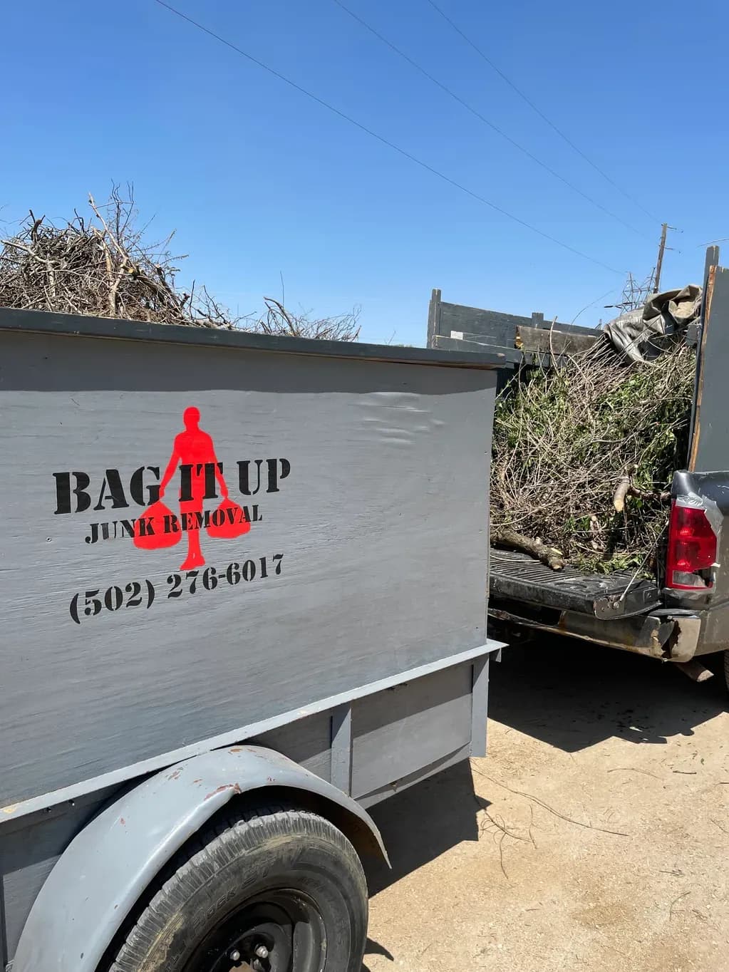 Bag It Up branded trailer at a Louisville job site